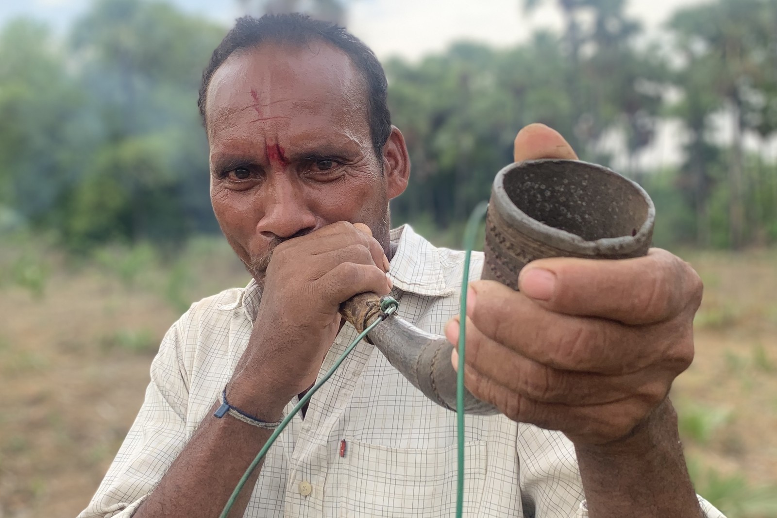 Konda Reddi man blowing a gaur horn