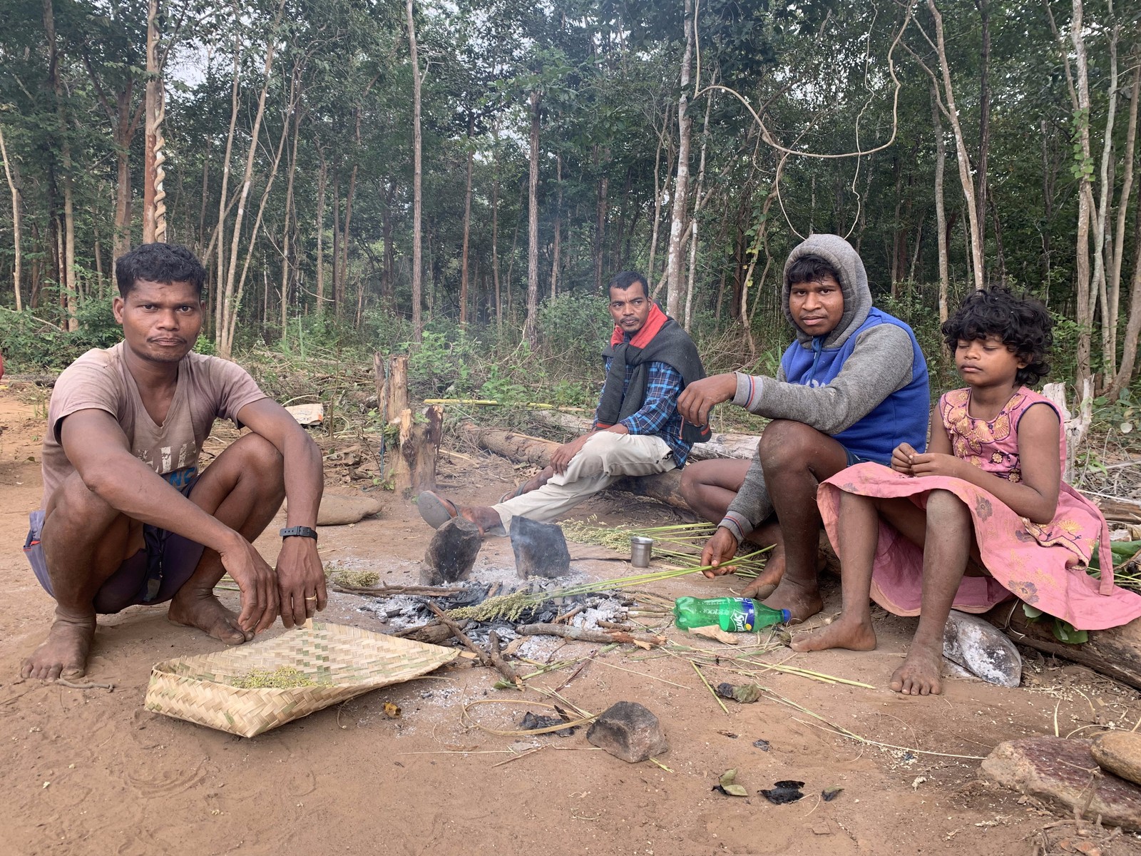 Koyas heating sorghum stalks to prepare a remedy for an asthmatic child