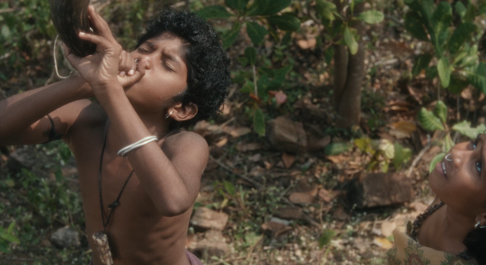 Young Shankar and Karuna blow a gaur horn